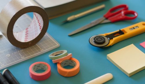 assorted-color office items on table