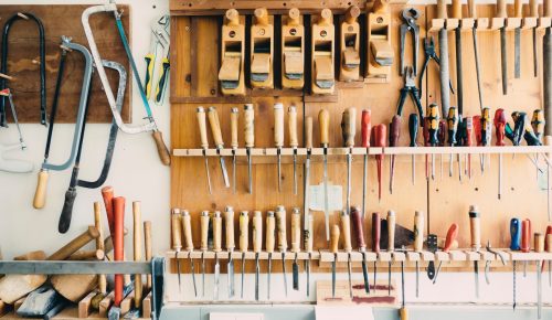 assorted handheld tools in tool rack